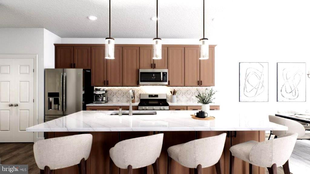 523 Linfield Road, Unit WESTERLY Royersford, PA 19468 - Photo 9 of 10 a kitchen with a dining table chairs microwave and refrigerator