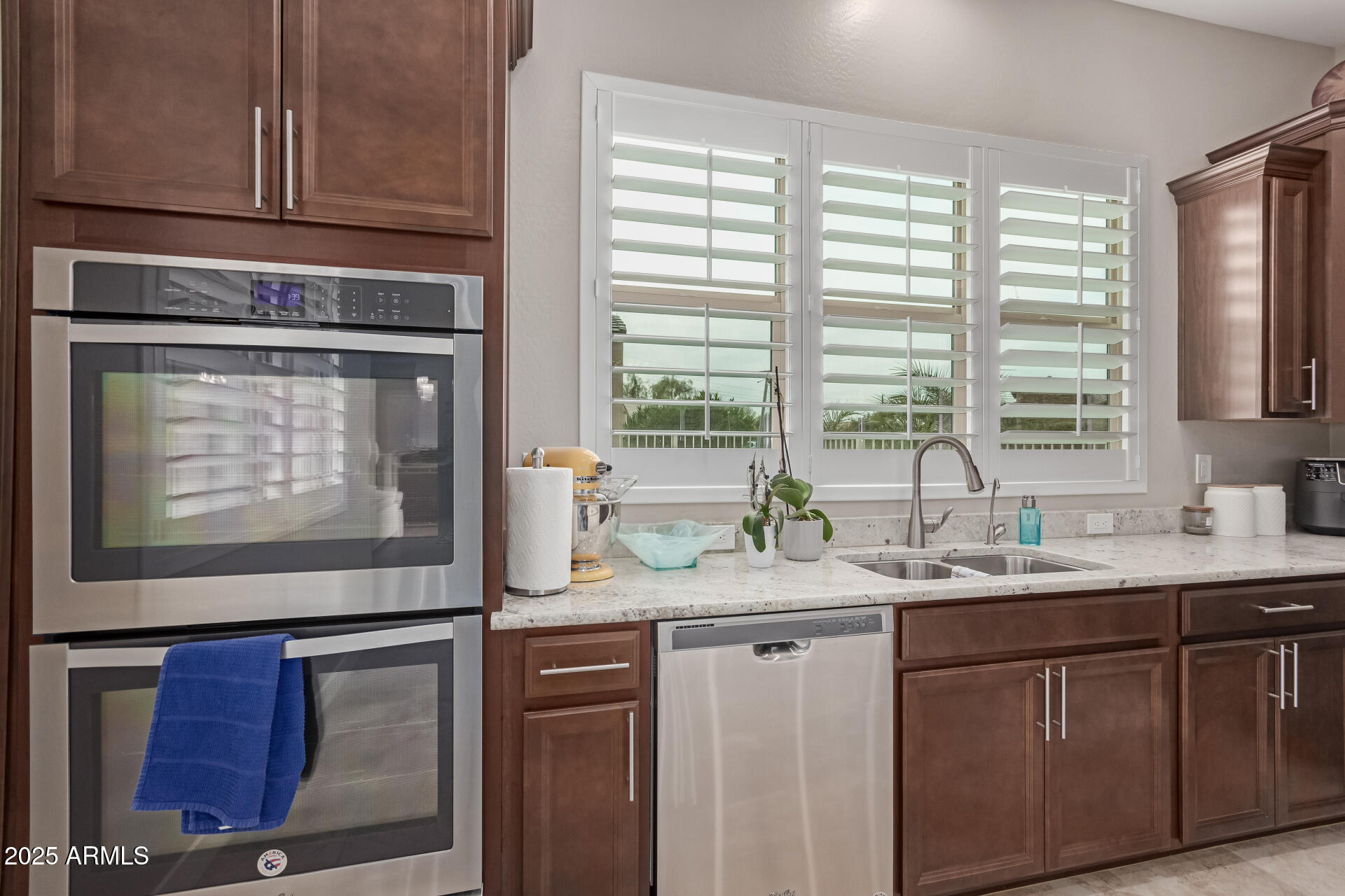 41737 West Cribbage Road Maricopa, AZ 85138 - Photo 12 of 35 a kitchen with stainless steel appliances granite countertop a sink and a microwave