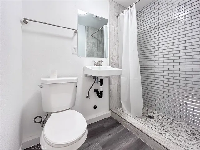 a white toilet sitting next to a bathroom sink