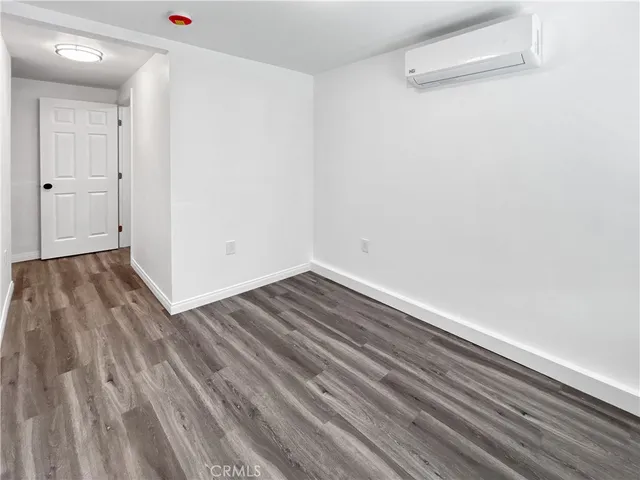 a view of room with wooden floor