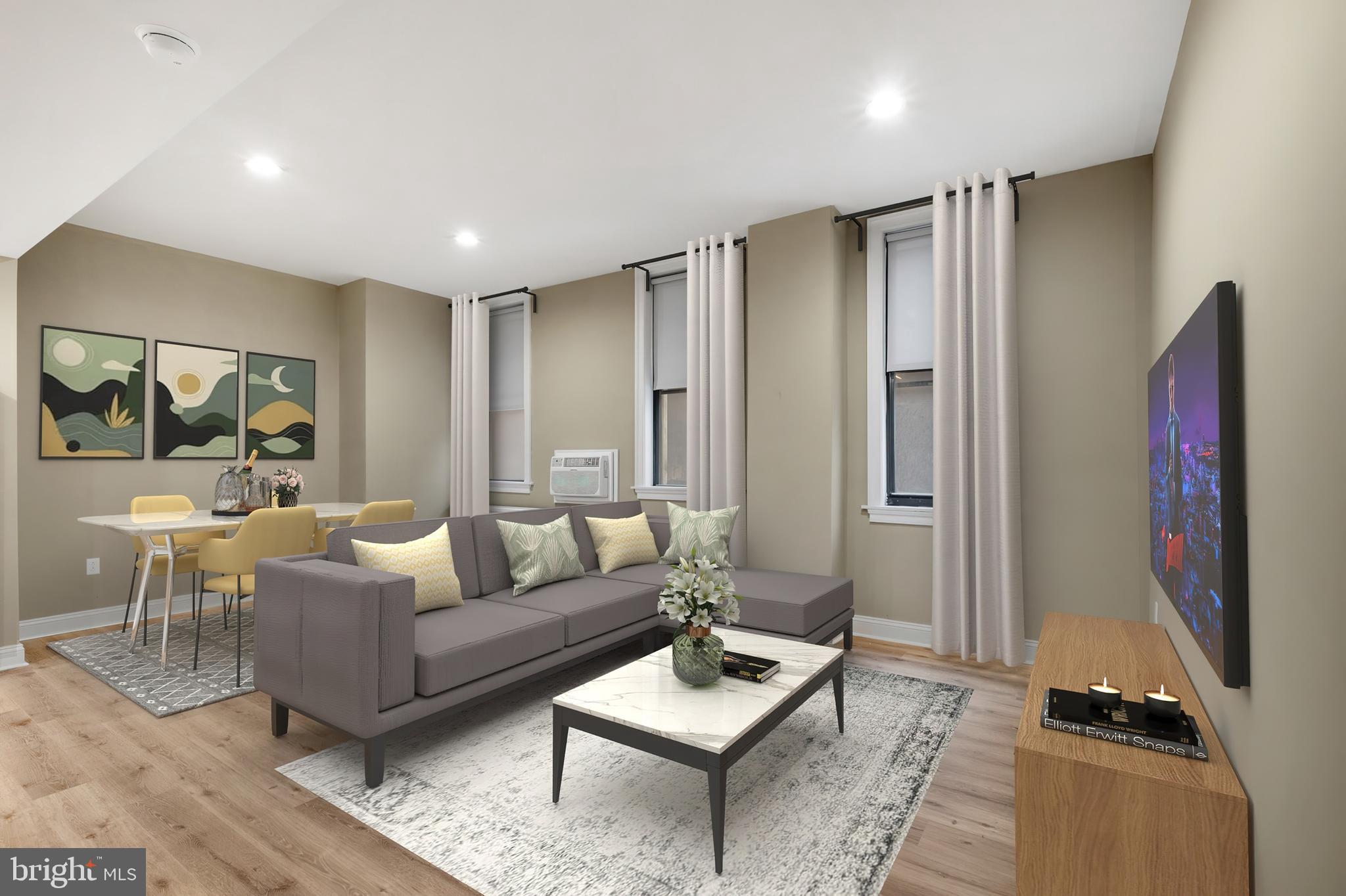 a living room with furniture a rug and a flat screen tv