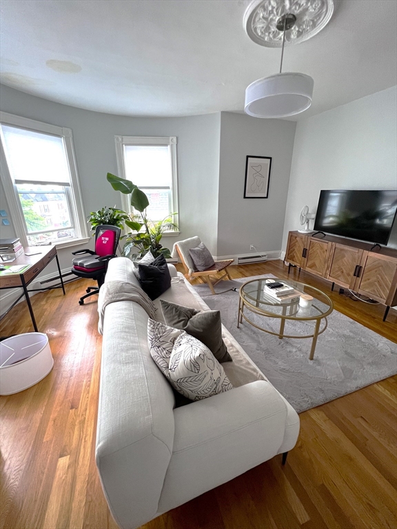 167 M Street, Unit 3F Boston, MA 02127 - Photo 1 of 7 a living room with furniture and a flat screen tv