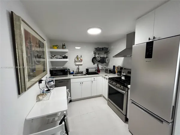 a kitchen with stainless steel appliances a sink stove and refrigerator