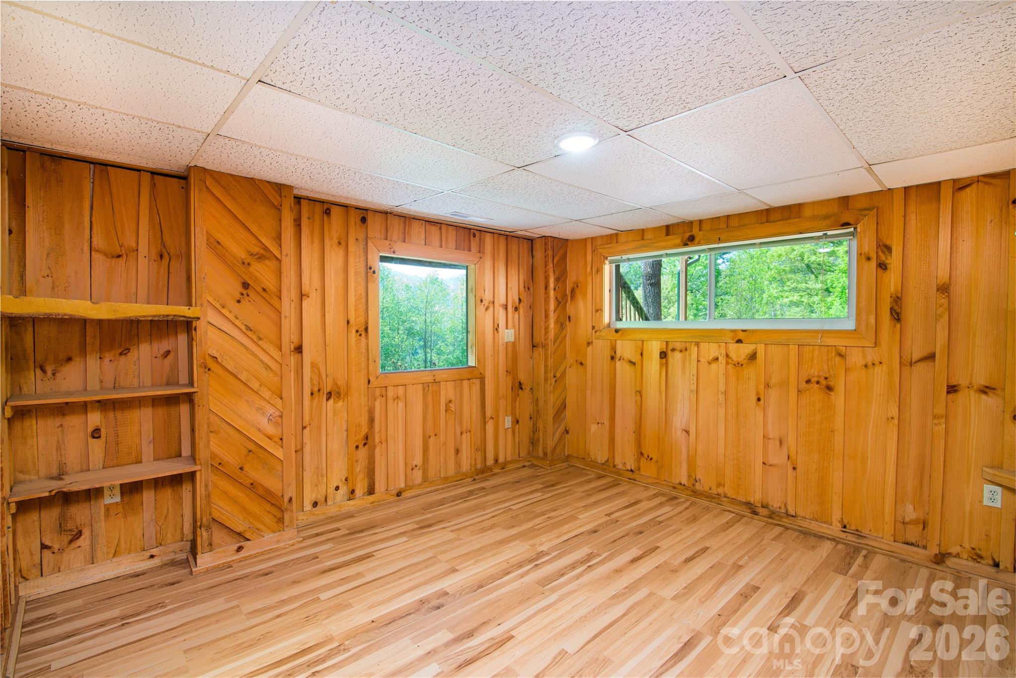 298 Timbuktu Road Sylva, NC 28779 - Photo 13 of 24 a view of an empty room with wooden floor and a window