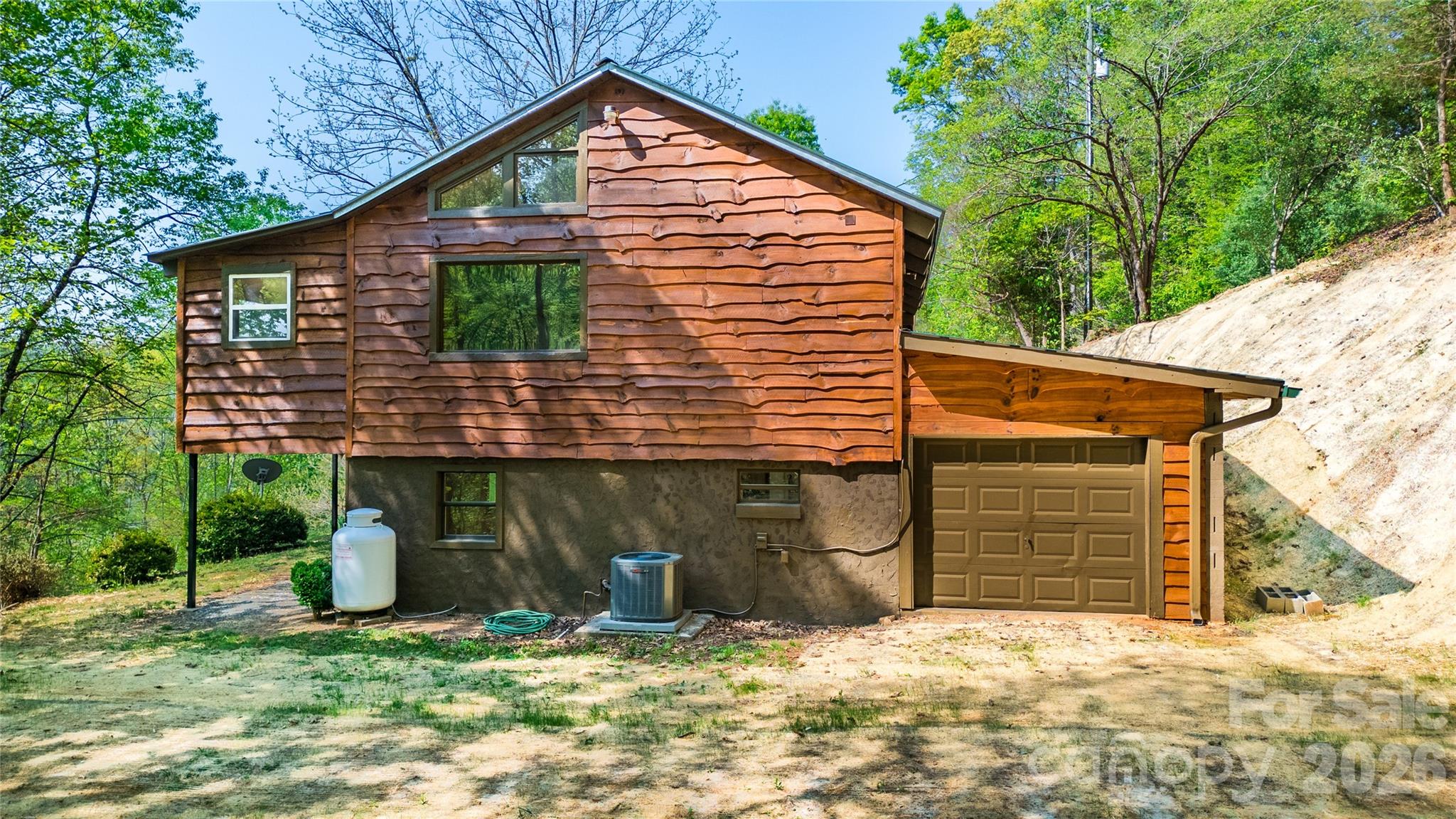 298 Timbuktu Road Sylva, NC 28779 - Photo 18 of 24 a view of a house with a yard