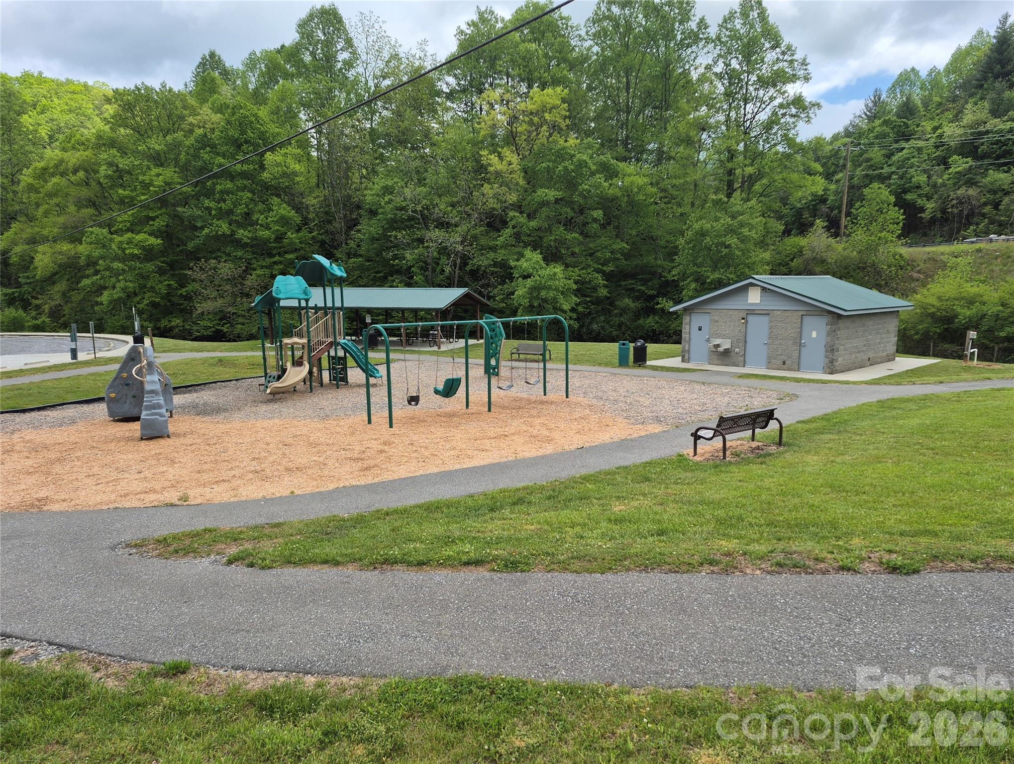 298 Timbuktu Road Sylva, NC 28779 - Photo 24 of 24 a view of a garden with a bench