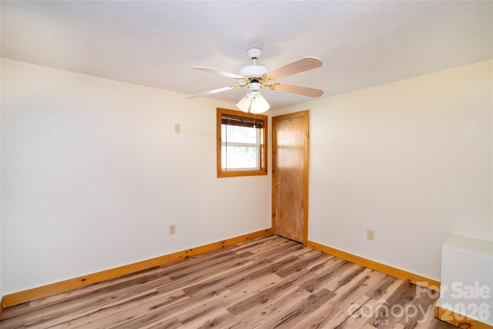 298 Timbuktu Road Sylva, NC 28779 - Photo 8 of 24 a view of empty room with wooden floor and fan