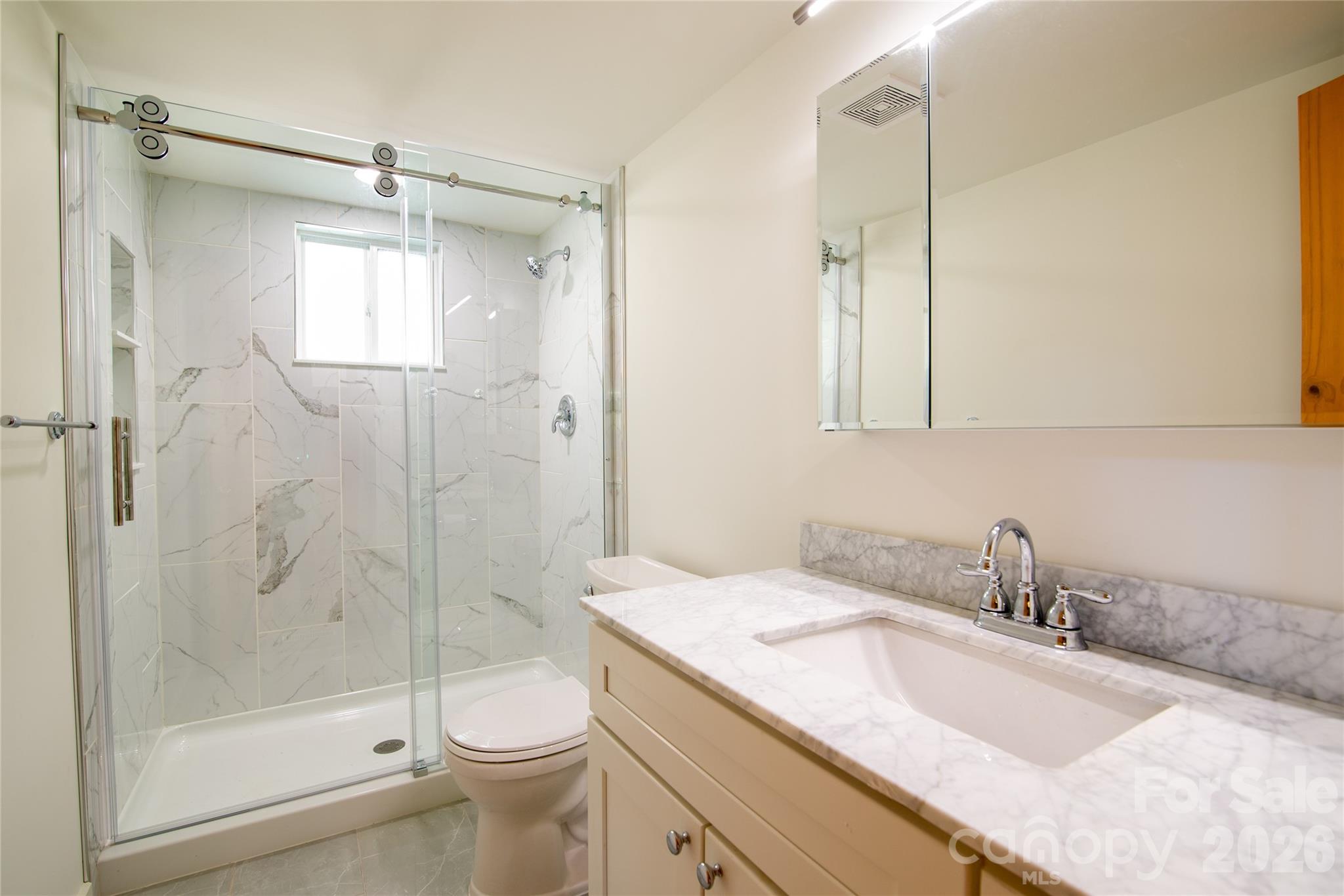 298 Timbuktu Road Sylva, NC 28779 - Photo 9 of 24 a bathroom with a sink a toilet and shower