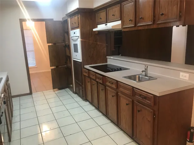 a kitchen with stainless steel appliances a sink and a refrigerator