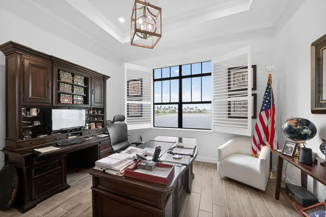 a view of a workspace with furniture and a window