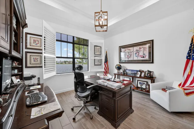 a view of a house with backyard and a tree