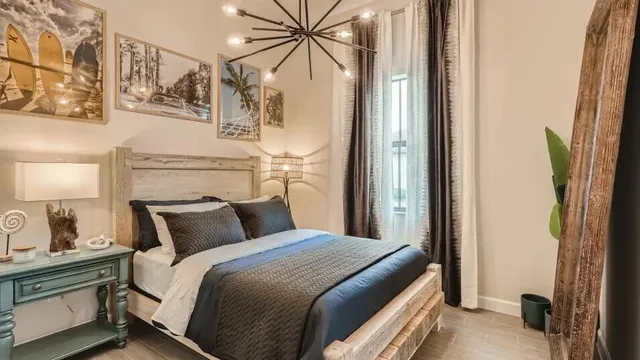 a bedroom with a bed and a chandelier