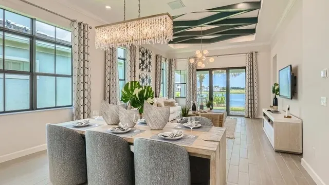 a dining room with furniture a chandelier and wooden floor