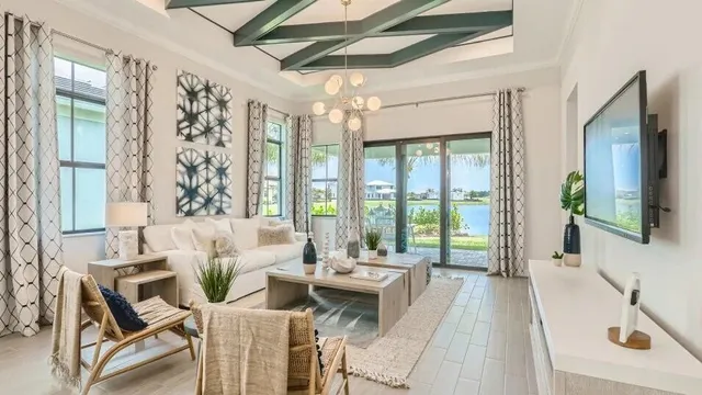 a bedroom with a bed and a flat tv screen on dresser