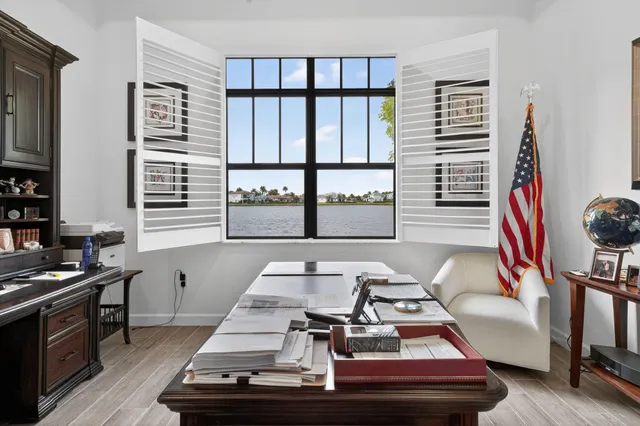 a living room with furniture a chandelier and a window