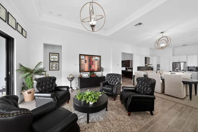 a living room with furniture and a chandelier
