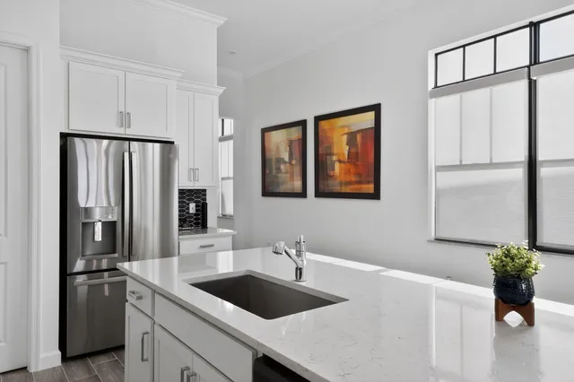 a kitchen with granite countertop a sink and cabinets