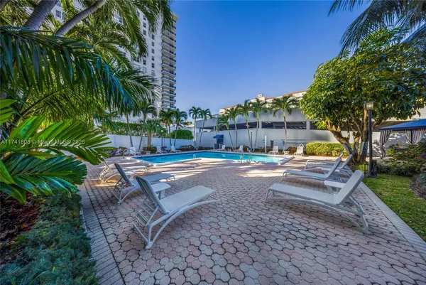 a swimming pool with outdoor seating and yard