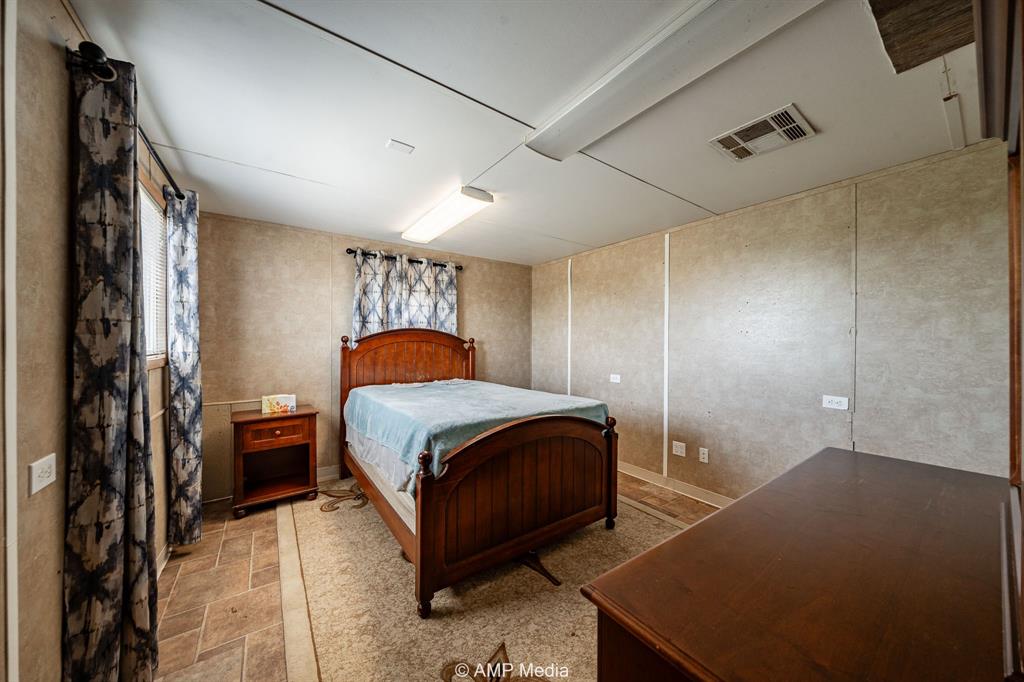 3641 A Carpenter Road Nocona, TX 76255 - Photo 12 of 27 a bedroom with a bed and a closet