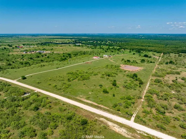 a view of a large yard with lots of green space