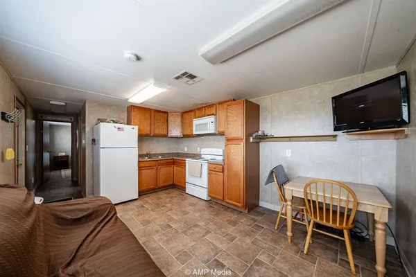 a kitchen with refrigerator a stove a sink and a microwave