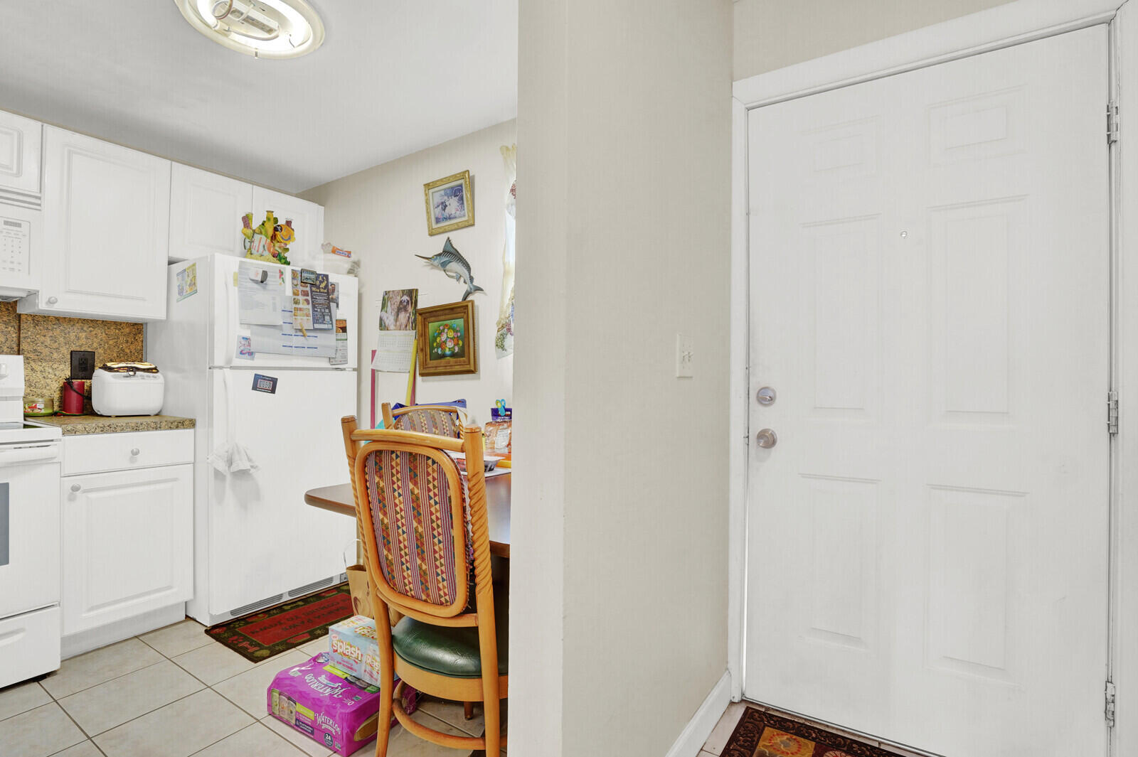 1505 Crescent Circle, Unit A11 Lake Park, FL 33403 - Photo 2 of 14 a utility room with cabinets washer and dryer