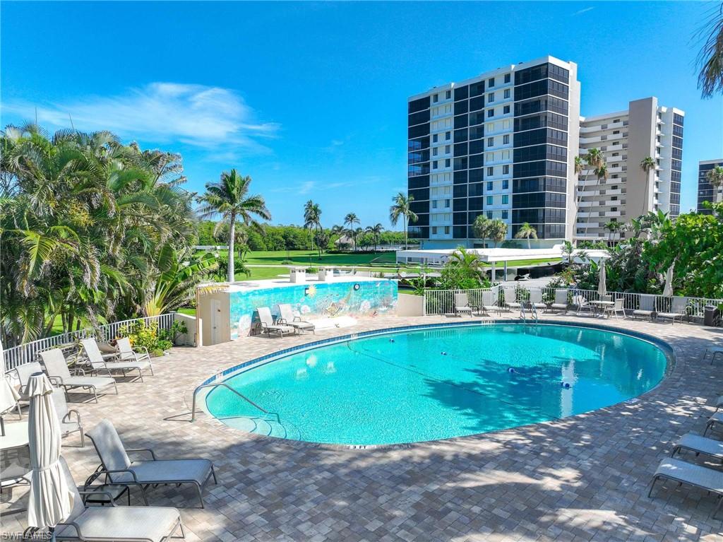 5 Bluebill Avenue, Unit 108 Naples, FL 34108 - Photo 2 of 49 Community pool with a patio