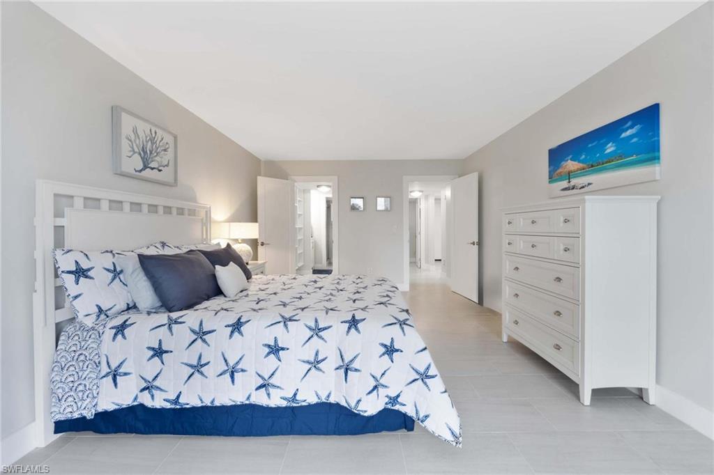 5 Bluebill Avenue, Unit 108 Naples, FL 34108 - Photo 22 of 49 Bedroom featuring light tile patterned flooring