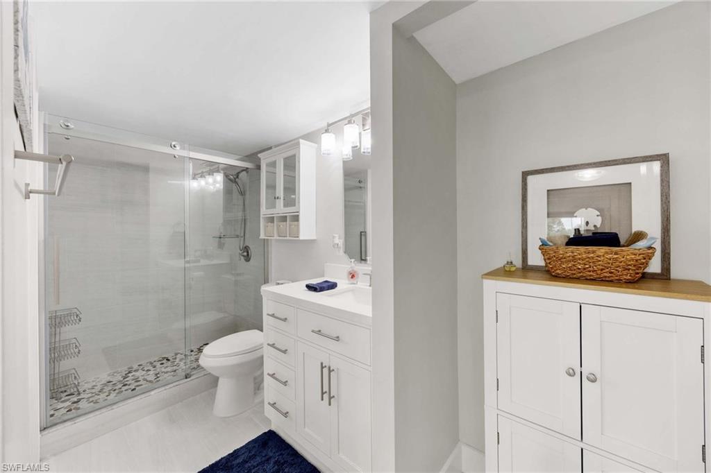 5 Bluebill Avenue, Unit 108 Naples, FL 34108 - Photo 25 of 49 Bathroom featuring vanity and a shower stall