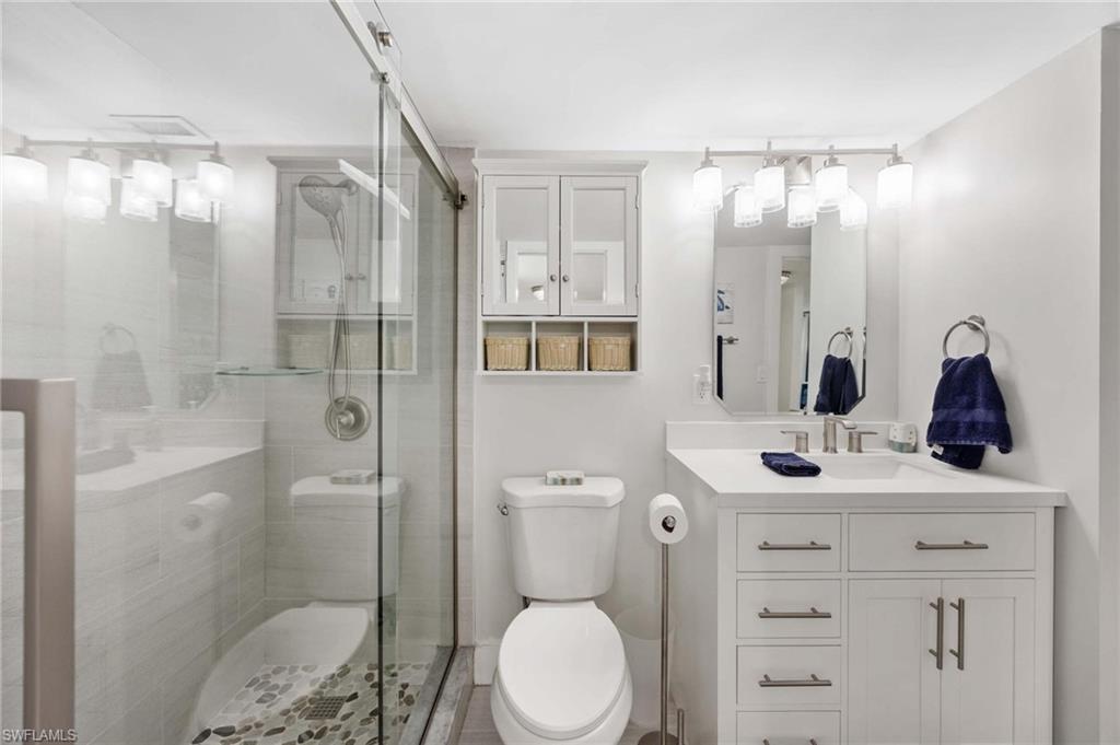 5 Bluebill Avenue, Unit 108 Naples, FL 34108 - Photo 26 of 49 Full bathroom with vanity and a stall shower