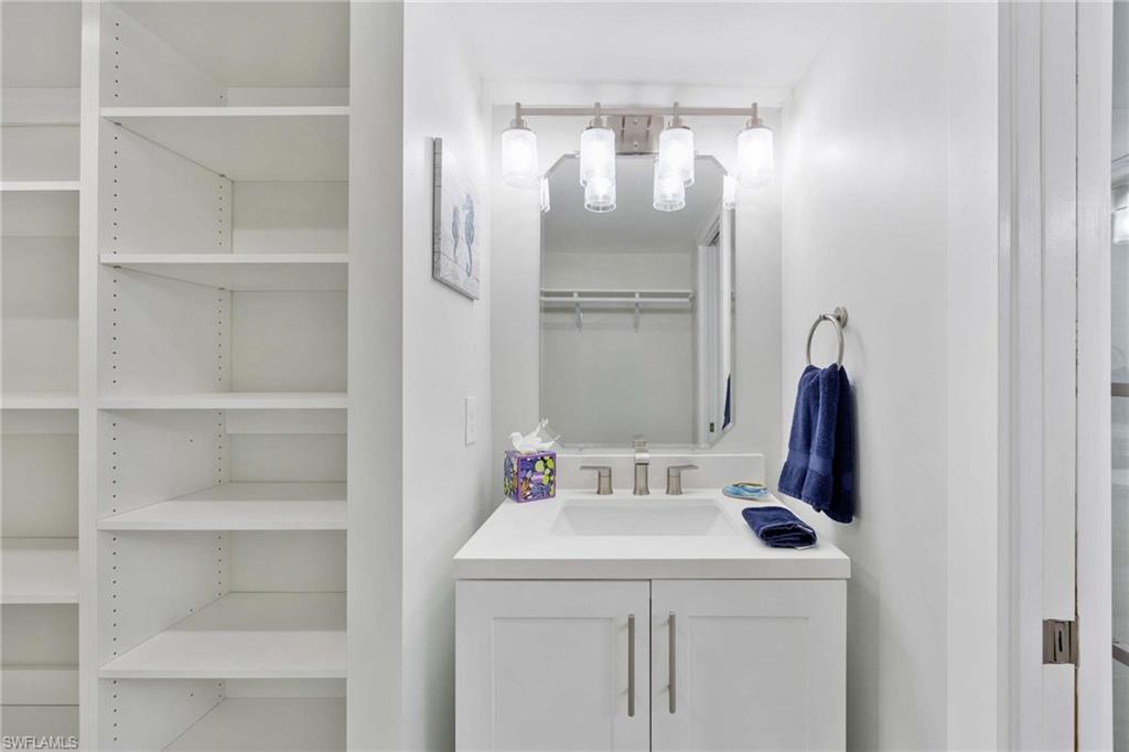 5 Bluebill Avenue, Unit 108 Naples, FL 34108 - Photo 27 of 49 Washroom featuring a sink