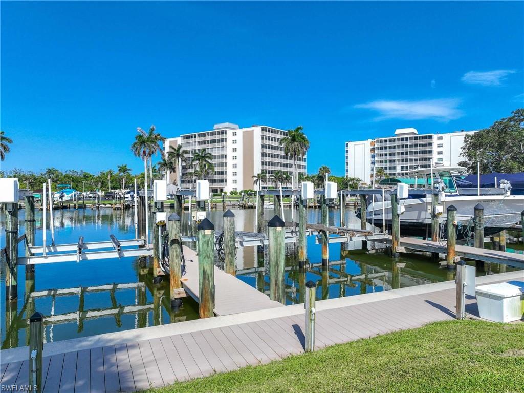 5 Bluebill Avenue, Unit 108 Naples, FL 34108 - Photo 33 of 49 Dock with boat lift and a water view