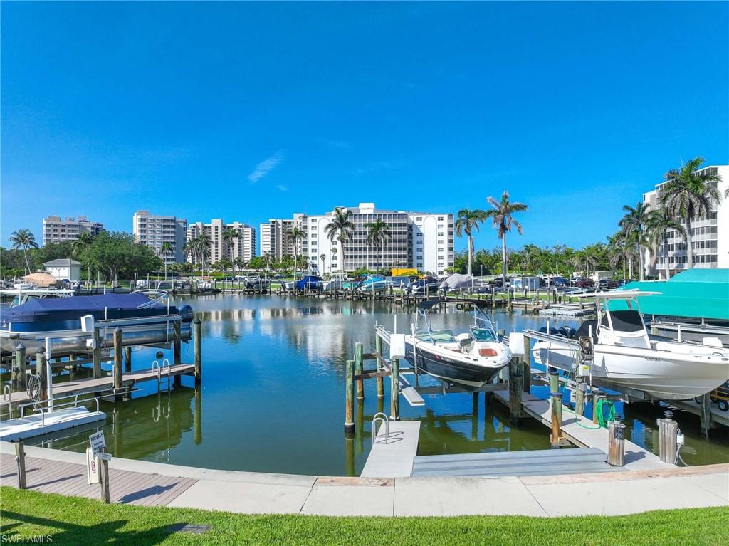 5 Bluebill Avenue, Unit 108 Naples, FL 34108 - Photo 34 of 49 Dock with boat lift and a water view