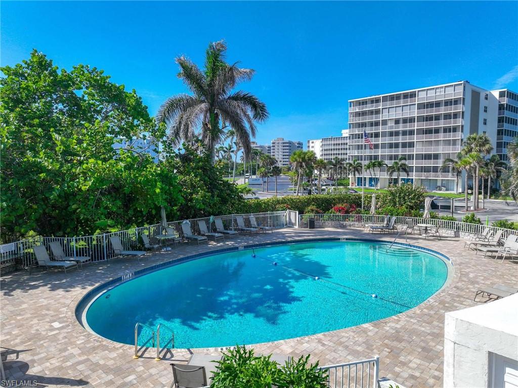 5 Bluebill Avenue, Unit 108 Naples, FL 34108 - Photo 38 of 49 Community pool featuring a patio