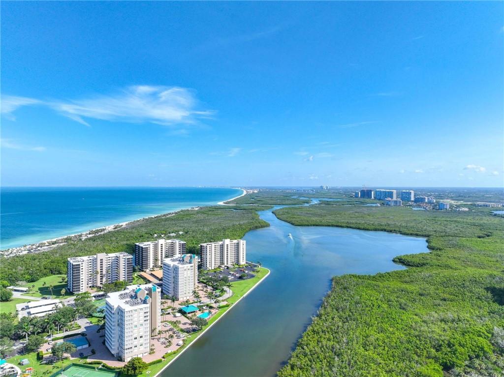 5 Bluebill Avenue, Unit 108 Naples, FL 34108 - Photo 41 of 49 Drone / aerial view of a nearby body of water