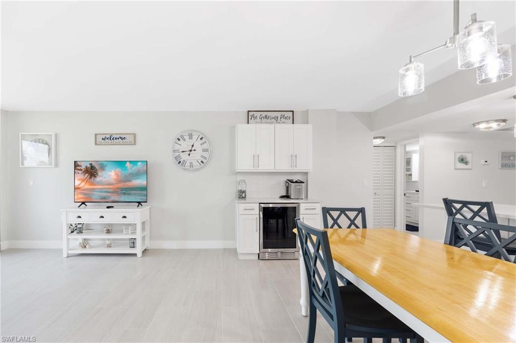 5 Bluebill Avenue, Unit 108 Naples, FL 34108 - Photo 10 of 49 Dining room with beverage cooler and baseboards