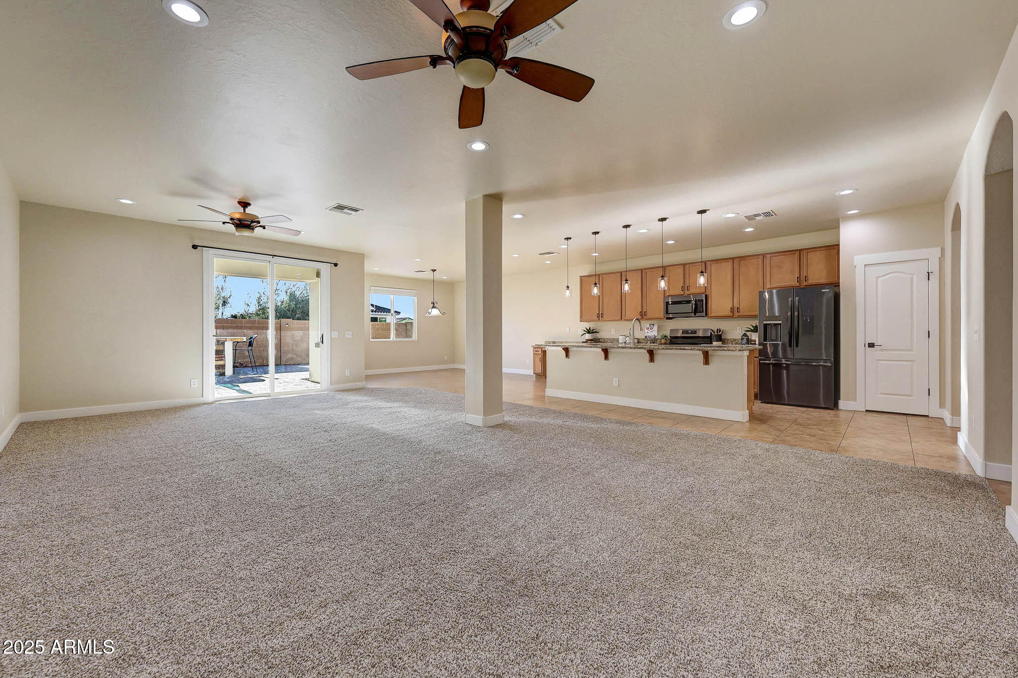20719 West Hamilton Street Buckeye, AZ 85396 - Photo 15 of 100 a view of a livingroom with furniture a kitchen and a window