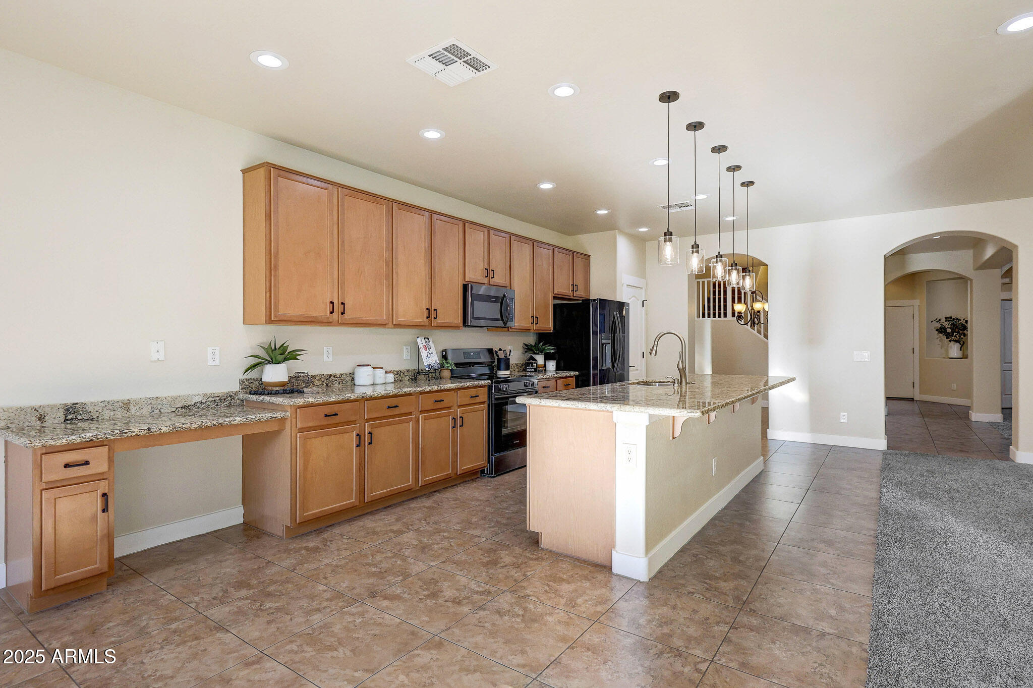 20719 West Hamilton Street Buckeye, AZ 85396 - Photo 18 of 100 a large kitchen with kitchen island a sink a center island and stainless steel appliances
