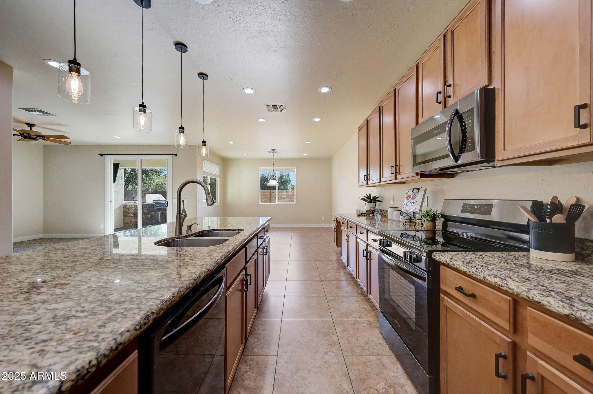 20719 West Hamilton Street Buckeye, AZ 85396 - Photo 20 of 100 a kitchen with granite countertop stainless steel appliances and wooden cabinets