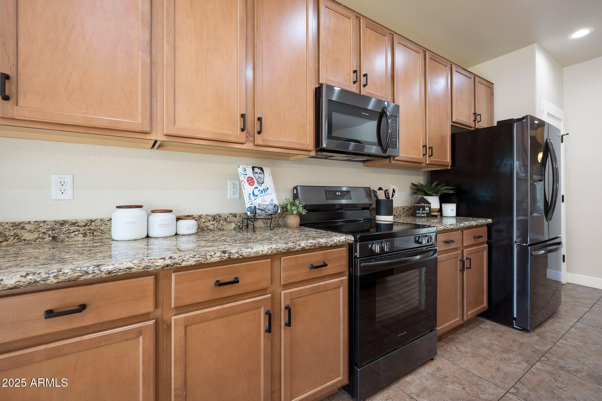 20719 West Hamilton Street Buckeye, AZ 85396 - Photo 25 of 100 a kitchen with stainless steel appliances granite countertop a refrigerator sink and stove