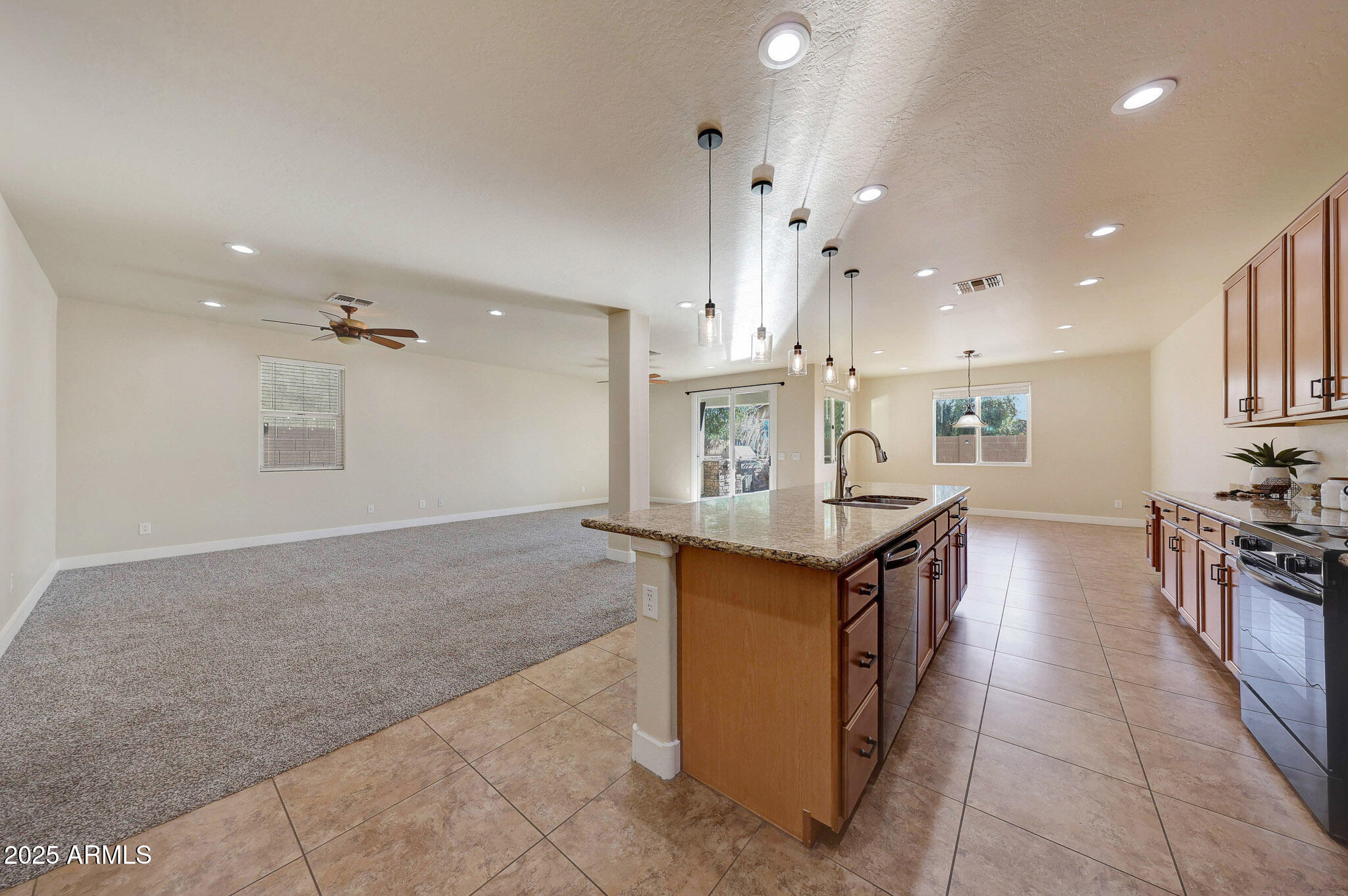 20719 West Hamilton Street Buckeye, AZ 85396 - Photo 27 of 100 a kitchen with stainless steel appliances granite countertop a stove and a refrigerator