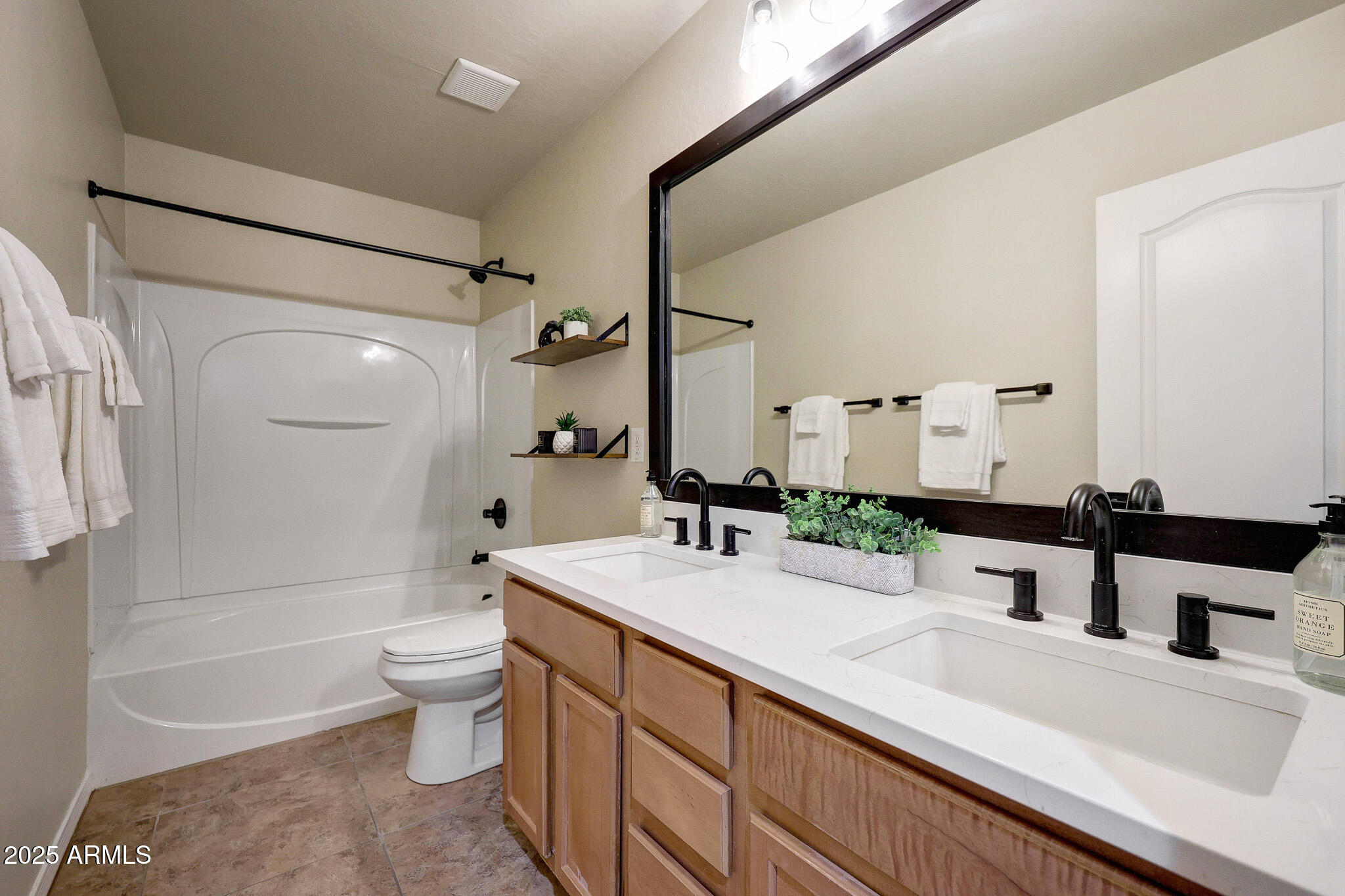 20719 West Hamilton Street Buckeye, AZ 85396 - Photo 33 of 100 a bathroom with a double vanity sink toilet mirror and bathtub
