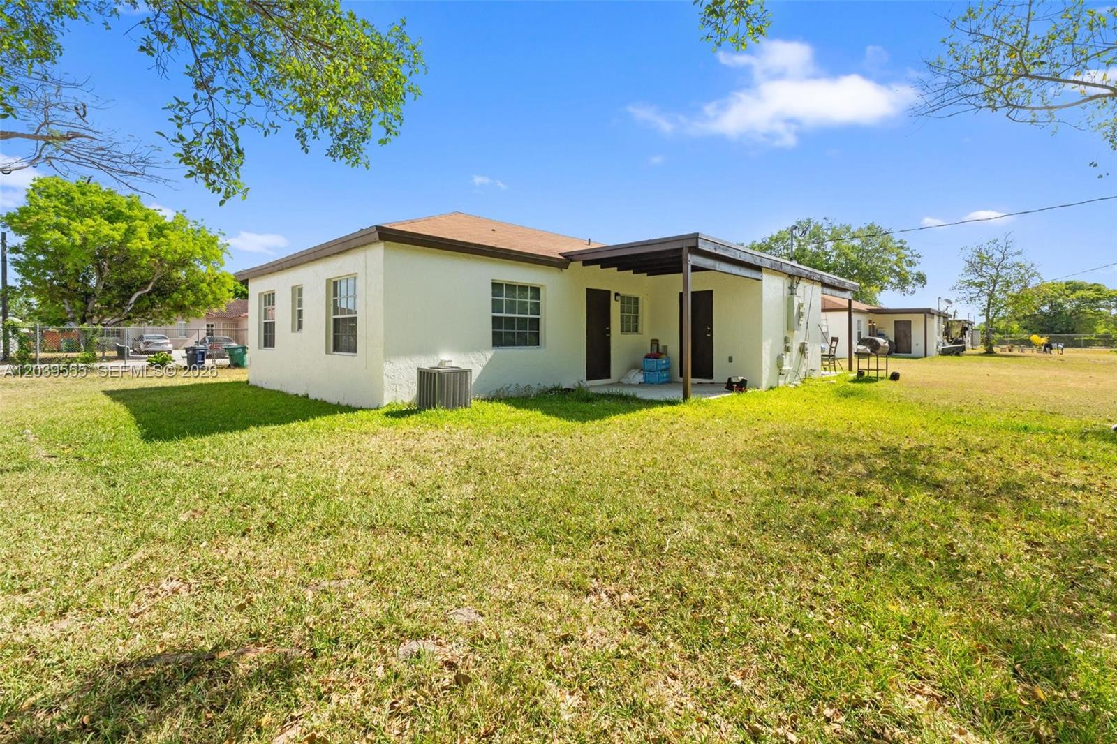 10544 Southwest 182nd Street Miami, FL 33157 - Photo 12 of 15 a front view of a house with a yard