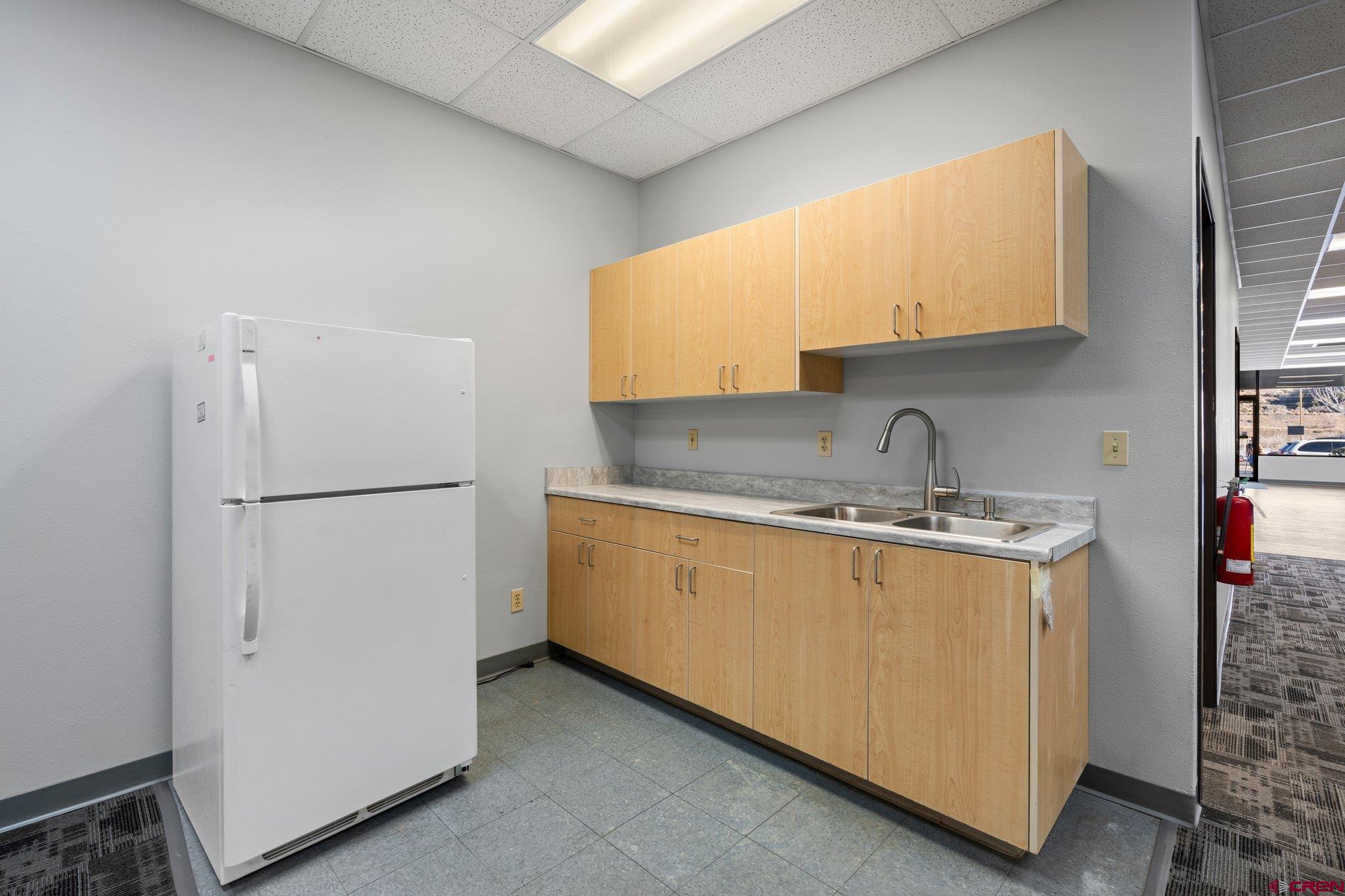 329 South Camino Del Rio Durango, CO 81303 - Photo 20 of 29 a kitchen with stainless steel appliances granite countertop a refrigerator a sink and white cabinets
