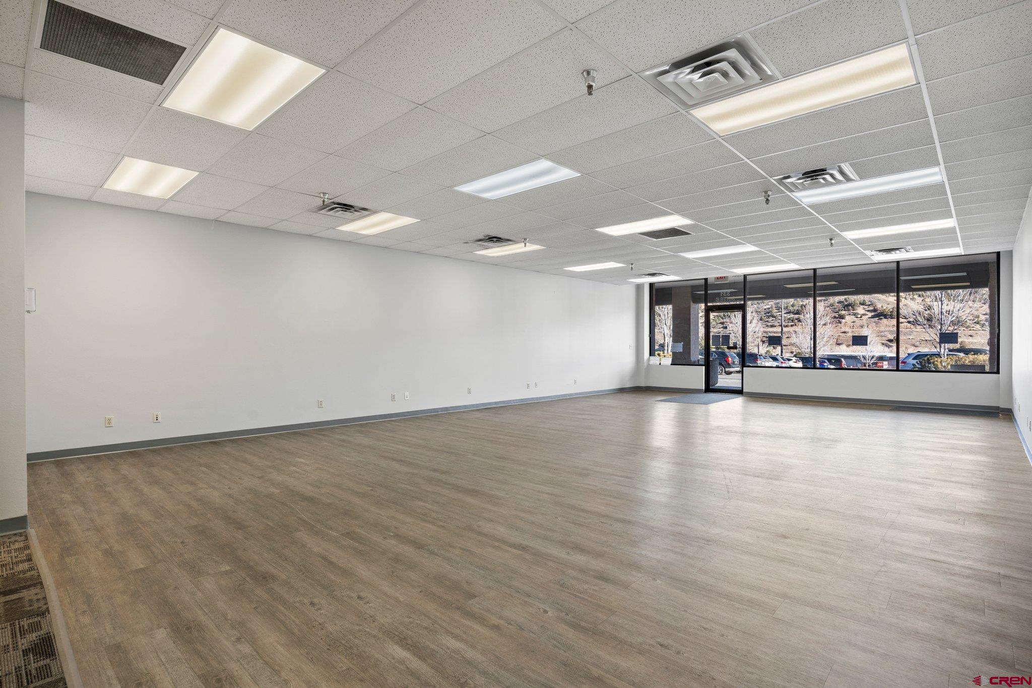 329 South Camino Del Rio Durango, CO 81303 - Photo 5 of 29 an empty room with wooden floor and windows