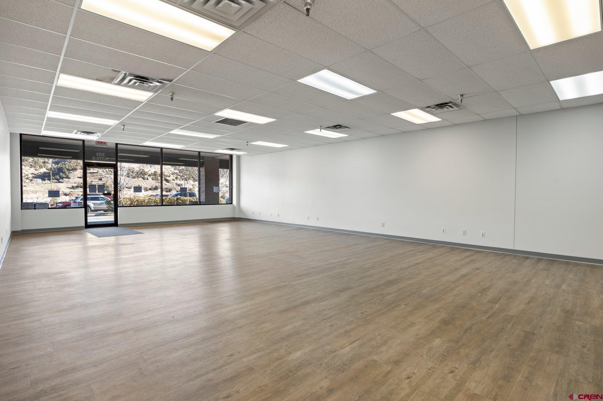 329 South Camino Del Rio Durango, CO 81303 - Photo 6 of 29 an empty room with wooden floor and windows