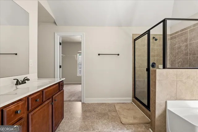 a bathroom with a double vanity sink a mirror and a shower