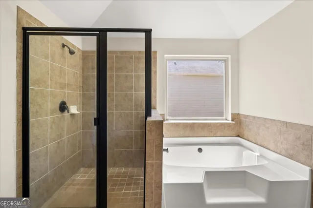 a bathroom with a bathtub and a shower