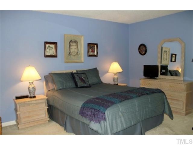 5412 Round Hill Lane Raleigh, NC 27616 - Photo 9 of 19 a bedroom with a bed and a lamp