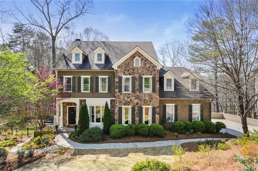 105 Grogans Landing Sandy Springs, GA 30350 - Photo 1 of 1 a front view of a house with lots of trees and plants